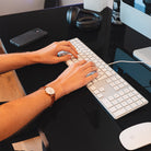 Bureau assis-debout électrique CONNECT noir en position haute dans un intérieur moderne.